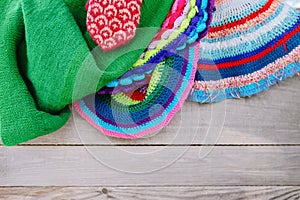 Knitted mat and covers on wooden background