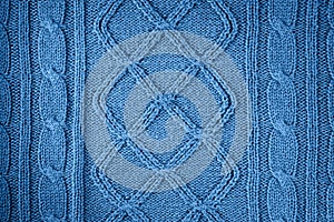 Knitted natural wool texture background in classic blue trendy color. Color of the year 2020