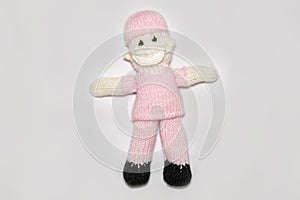 Knitted nurse, front line worker on white background. covid 19