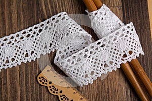 Knitted openwork linen ribbon tapes in rural style of rustics cotton eco natural on wood ground
