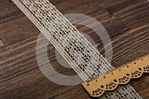 Knitted openwork linen ribbon tapes in rural style of rustics cotton eco natural on wood ground