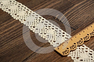 Knitted openwork linen ribbon tapes in rural style of rustics cotton eco natural on wood ground