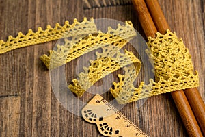 Knitted openwork linen ribbon tapes in rural style of rustics cotton eco natural on wood ground