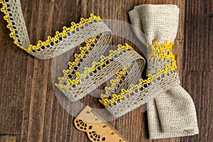 Knitted openwork linen ribbon tapes in rural style of rustics cotton eco natural on wood ground