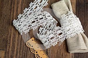 Knitted openwork linen ribbon tapes in rural style of rustics cotton eco natural on wood ground