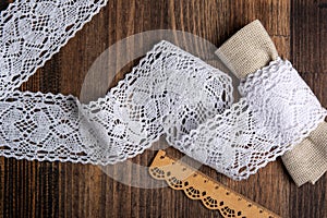 Knitted openwork linen ribbon tapes in rural style of rustics cotton eco natural on wood ground