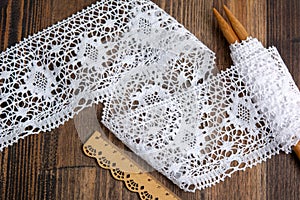 Knitted openwork linen ribbon tapes in rural style of rustics cotton eco natural on wood ground