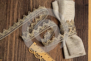 Knitted openwork linen ribbon tapes in rural style of rustics cotton eco natural on wood ground