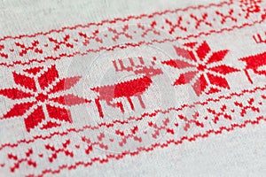 Knitted red and white ornament with deer