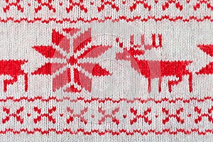 Knitted red and white ornament with deer