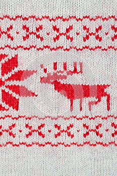 Knitted red and white ornament with deer