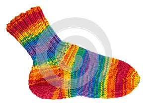 Knitted sock from yarn. Handmade hobby knitting. Rainbow, colorful acrylic, wool or cotton thread