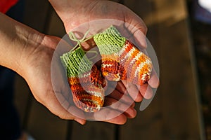 Knitted socks for premature babies in the hands