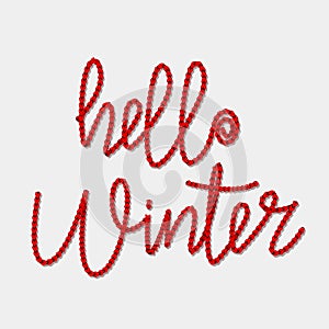 Knitted text `hello winter` of red threads. winter holidays concept