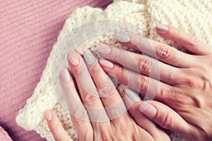 Knitted texture manicure on nails from pink and gray colors