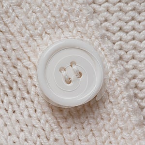 Knitted texture with a white button