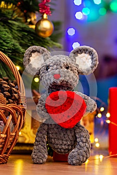 Knitted toy mouse under the Christmas tree