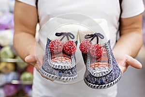 Knitted warm home Slippers in the hands of a man