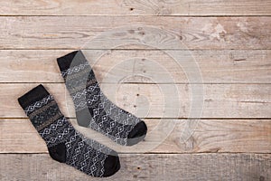 Knitted warm socks on the wooden background