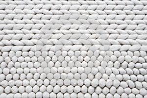 Knitted white bath mat or toilet mat texture background, knitting texture. Top view of horizontal Stockinet