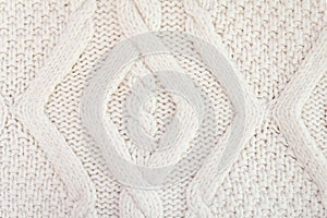 Knitted white fabric texture with a relief pattern