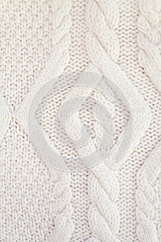 Knitted white fabric texture with a relief pattern