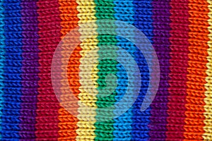 A knitted wool fabric in the colors of the rainbow. Fun background. Vertical strip
