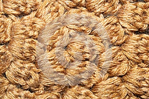 Knitted woolen background. brown soft fabric close up