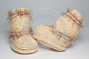 Knitted woolen bootees for young children