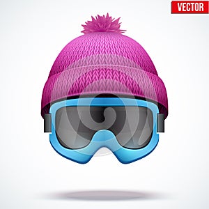 Knitted woolen cap with snow goggles. Winter