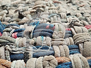 Knitted woolen fabrics that are starting to break down are made into doormats
