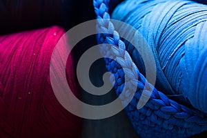 knitted yarn in handmade basket. Knitting with hook. Blu, indigo, burgundy threads. knitted fabric. Handmade and hobby