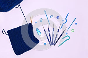 Knitting and crocheting flatlay.Blue yarn skein, crochet hook, row counter on white background isolated.Knit hat process