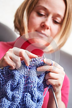 Knitting. female hands with needle and thread