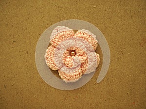 Knitting flower, crochet work on wood background