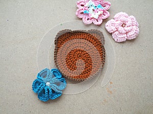 Knitting flower, crochet work on wood background
