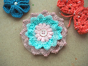 Knitting flower, crochet work on wood background