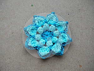 Knitting flower, crochet work on wood background