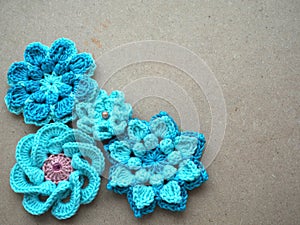 Knitting flower, crochet work on wood background