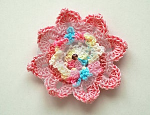 Knitting flower, crochet work on wood background