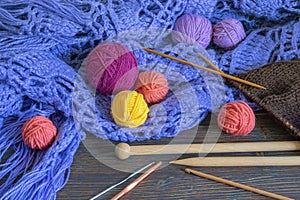 Knitting and hobby concept. Colorful balls of wools, knitting needles and crochet hooks