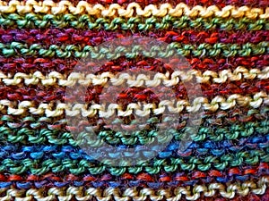 Knitting. Knitted multicolored fabric. Knitting texture. Background image. Hobbies leisure crafts