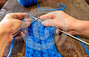 Knitting with knitting needles :