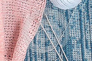 Knitting needles on a background associated texture of yarn