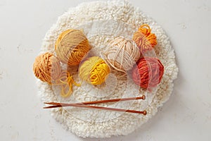 Knitting needles and colorful woolen balls