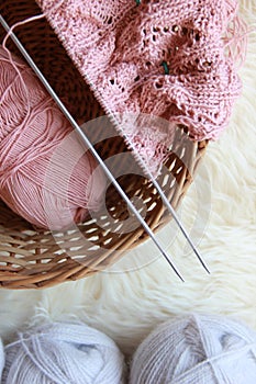 Knitting needles with yarn and a ball of thread,