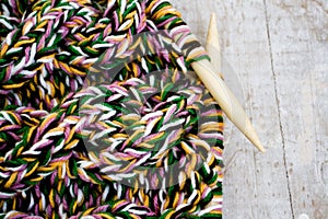 Knitting needles and yarn on wooden background