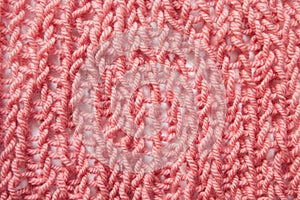 Knitting pink or red textured wool background, close up, vintage style