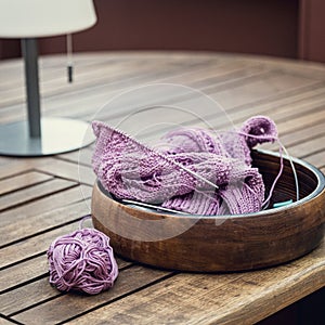 Knitting project of knitting women's pink sweater in progress.