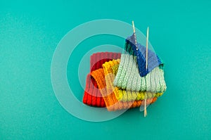 Knitting a rainbow scarf and hat Blue background